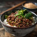 Close-up of a Korean Ground Beef Bowl with vibrant colors and textures, featuring beef, rice, and broccoli.