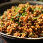Close-up view of cooked ground chicken sautéed with garlic.