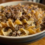 Close-up of a steaming bowl of Easy Beef and Noodles, showcasing juicy beef and egg noodles.