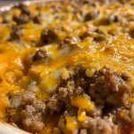 Close-up view of a hearty Hobo Casserole with ground beef and cheese.