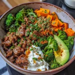 A close-up side view of a Hot Honey Beef Bowl with vibrant colors and textures.