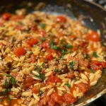 Close-up view of Tomato Ground Turkey Orzo served in a bowl.