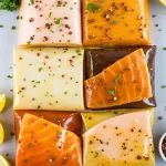 Close-up of salmon fillets marinated with herbs and spices, beautifully arranged.