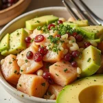 A close-up shot of a vibrant Salmon and Avocado Poke Bowl featuring diced salmon, avocado, cucumber, and edamame.