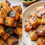 Close-up shot of golden-brown Honey Garlic Salmon Bites garnished with green onions and sesame seeds.