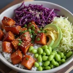 Close-up of a Honey Garlic Salmon Poke Bowl featuring diced salmon, avocado, and colorful vegetables.