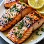 Close-up of grilled salmon fillet glazed with honey garlic soy sauce, garnished with green onions.