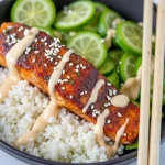 Close-up of Honey Garlic Salmon fillet glazed with honey sauce, garnished with green onions.