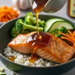 Close-up of a Honey Garlic Salmon Bowl with salmon, rice, broccoli, and avocado.