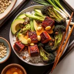Close-up of a chili honey garlic salmon bowl with vibrant vegetables and rice.