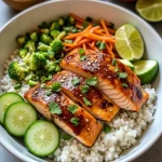 Close-up of a Healthy Sweet Chili Salmon Bowl featuring salmon fillets, quinoa, broccoli, and avocado.