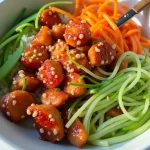 Close-up of a Honey Garlic Salmon Bowl featuring salmon, rice, broccoli, and avocado.