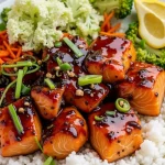 Close-up of honey garlic salmon rice bowl with broccoli and carrots.