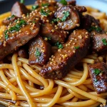 Close-up of Sweet and Spicy Garlic Steak Pasta with vibrant colors and textures.