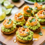 Close-up of colorful shrimp guacamole bites on tortilla chips, garnished with cilantro.
