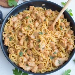 Creamy Marry Me Chicken Pasta on a plate, garnished with fresh parsley.