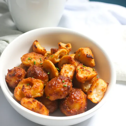 Bite-sized salmon cubes presented on a rustic plate, glistening with a sweet glaze, surrounded by soft shadows.