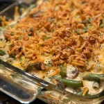 Close-up view of Cheddar Bay Green Bean Casserole with a golden brown topping.