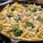 Close-up of creamy Chicken and Broccoli Alfredo pasta in a bowl.