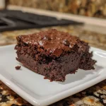 Close-up view of a chocolate cobbler dessert in a slow cooker.