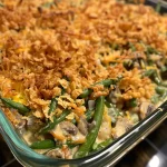 Close-up of a golden-brown Southern Green Bean Casserole with crispy onion topping.