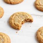 Close-up of golden brown sugar cookies on a wooden surface.