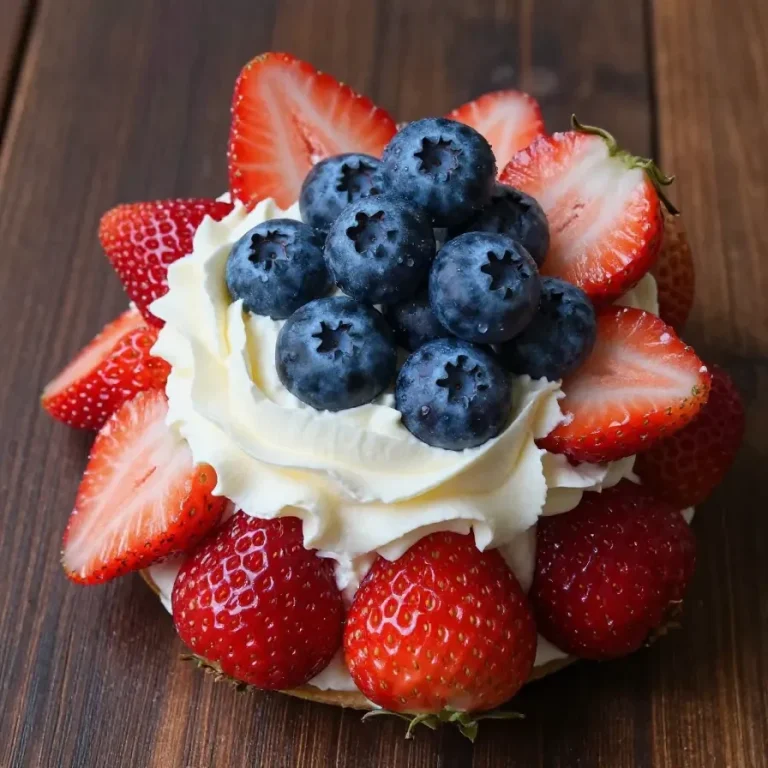 Close-up of red, white, and blue cheesecake-filled strawberries arranged on a plate.