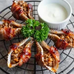 Delicious smoked shotgun shells filled with meat and cheese on a wooden platter