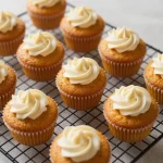 Delicious pumpkin cream cheese muffins on a wooden table