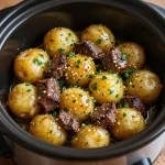 Delicious slow cooker garlic butter beef bites served with golden potatoes