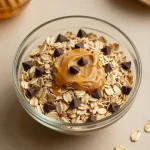 A close-up of oatmeal protein balls made with peanut butter, displayed on a wooden board.